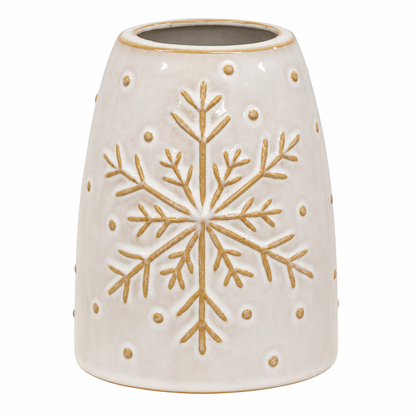 A cream-colored ceramic pot or planter with a raised gold snowflake design on the front and small gold dots around the surface, set against a plain white background.