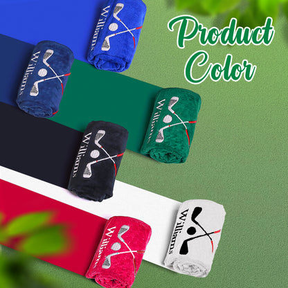 A display of black, green, navy blue, and blue golf towels, each with the customer's personalized embroidered last name, allowing for a comparison of the colors.