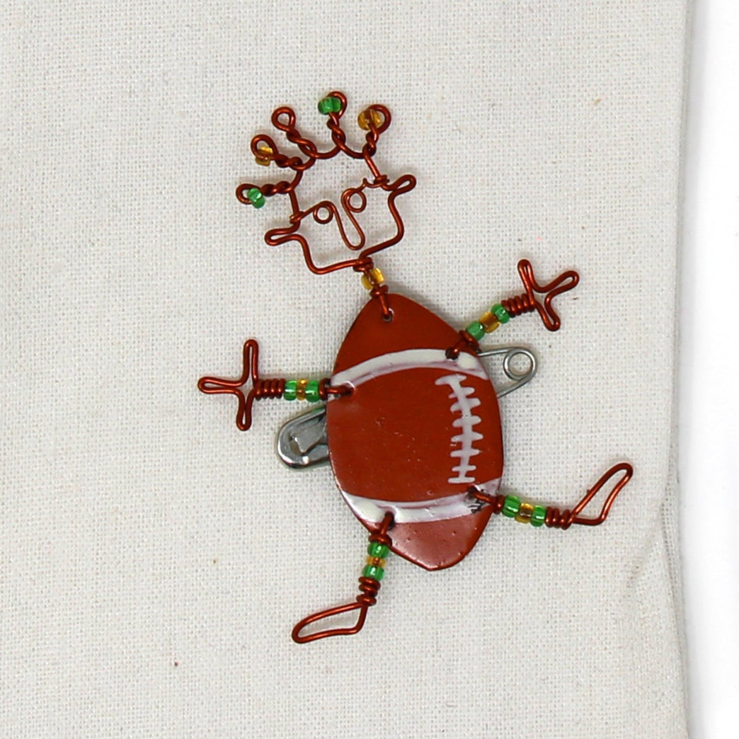 Kenyan artisan sports-themed brooch, crafted with sustainable and recycled materials.