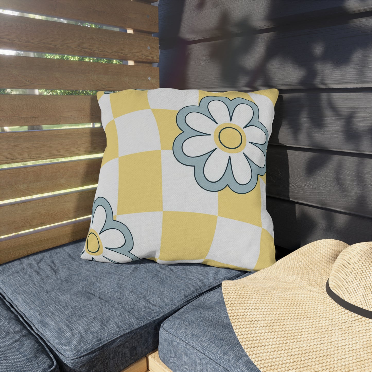 Bright garden pillow featuring yellow and white check design with cheerful flowers