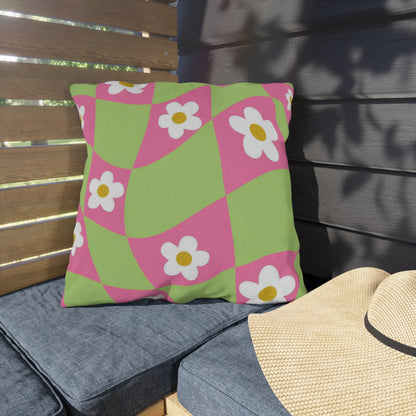 Decorative floral pillow on outdoor bench with soft spring-inspired colors