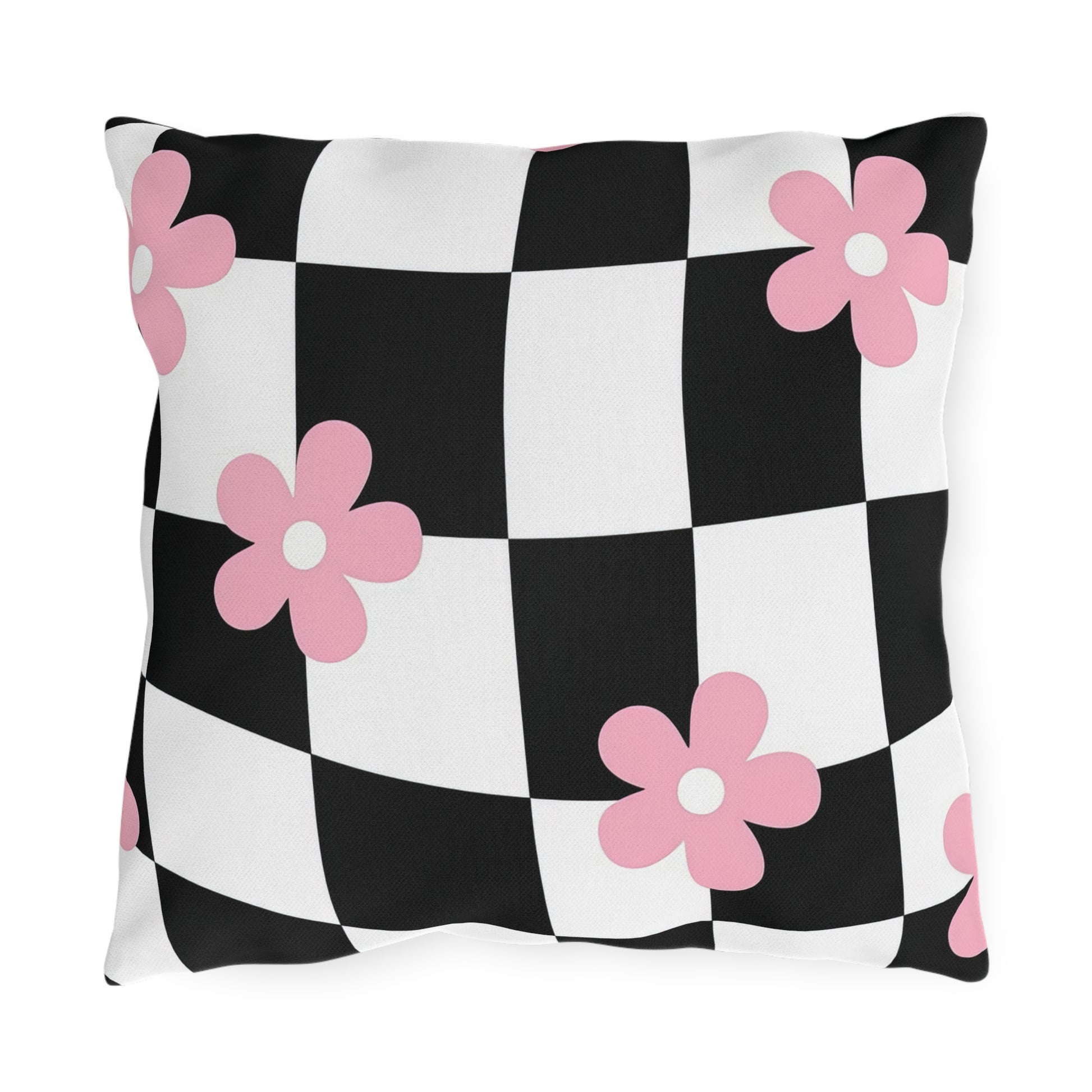 Black and white checkered outdoor pillow with soft pink floral print on a patio bench