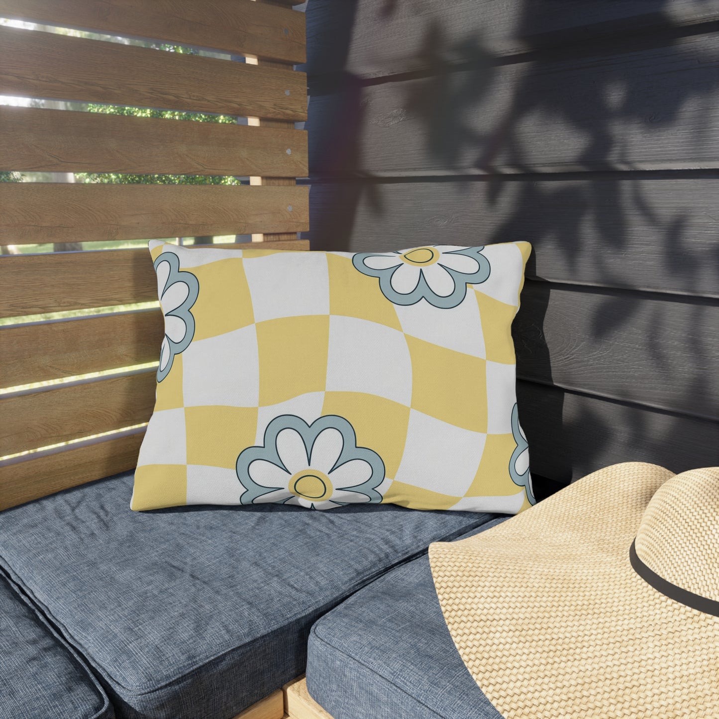 Outdoor lumbar pillow with cheerful yellow and white base and floral design