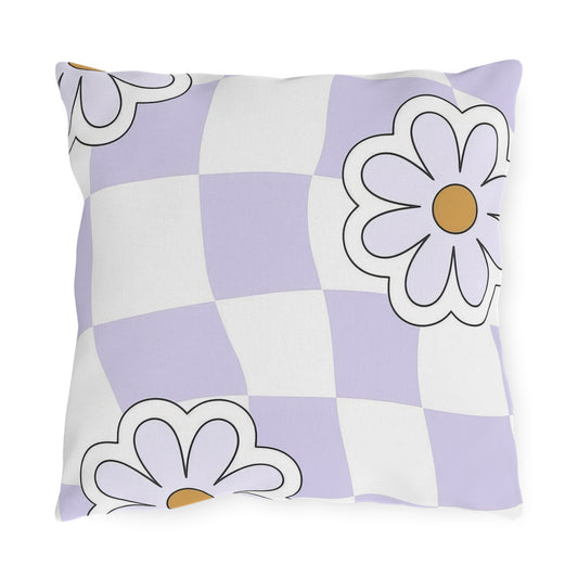 Lavender checkered floral outdoor pillow in purple, white, and orange on garden chair