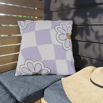 Close-up of lavender checkered outdoor pillow with floral design in purple and orange