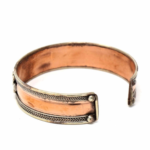 Adjustable fair trade copper cuff bracelet with brass and silver accents, handcrafted by skilled artisans.