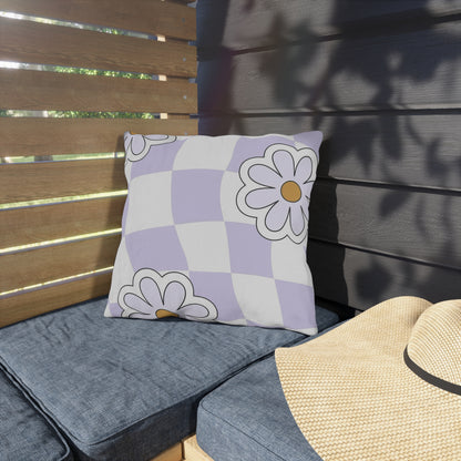 Colorful patio pillow featuring purple and orange flowers on a white checkered background