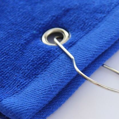 A close-up view of a blue golf towel, focusing on the sturdy clip and eyelet, showing the attachment point for easy hanging on golf bags or backpacks.