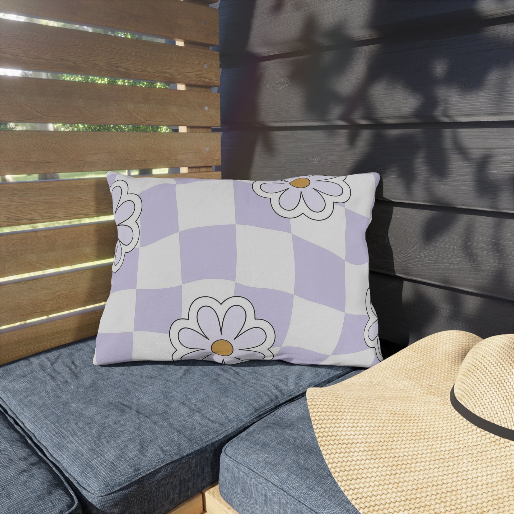 Water- and UV-resistant floral lumbar pillow styled in backyard seating area

