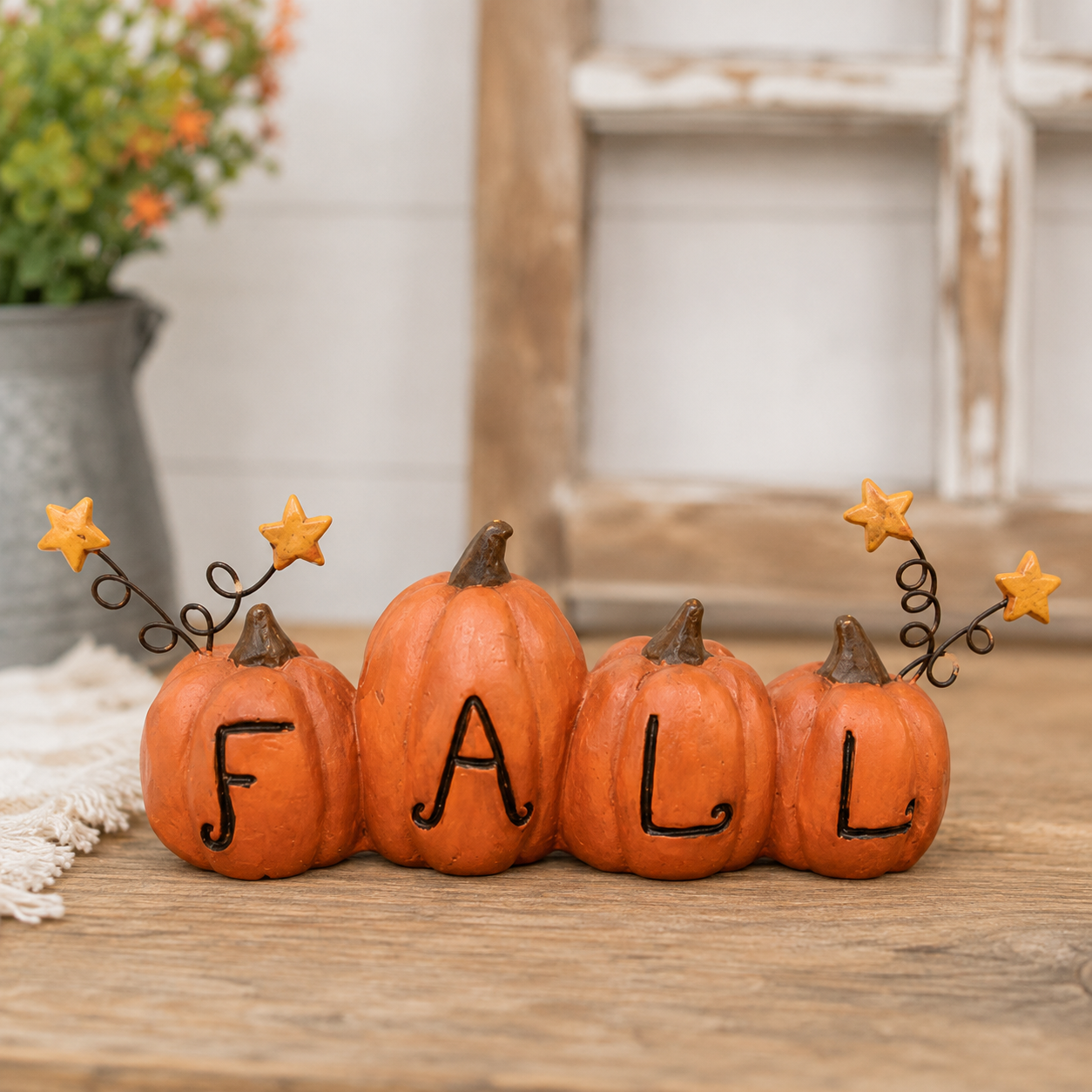 Resin fall pumpkin accent with miniature star sprays extending from wire stems for primitive autumn decor.