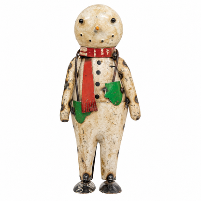 A vintage hand-painted tin snowman figurine with a weathered cream-colored body, black speckles, a red scarf, and green pockets, set against a plain white background.