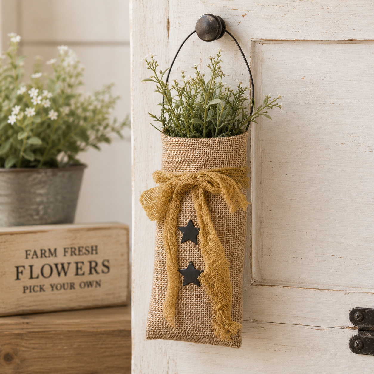 Small natural burlap star hanging bag with primitive country style, black wire hanger, and rustic decorative accents
