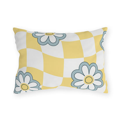 Yellow checkered lumbar pillow with soft blue and white floral accents for garden seating