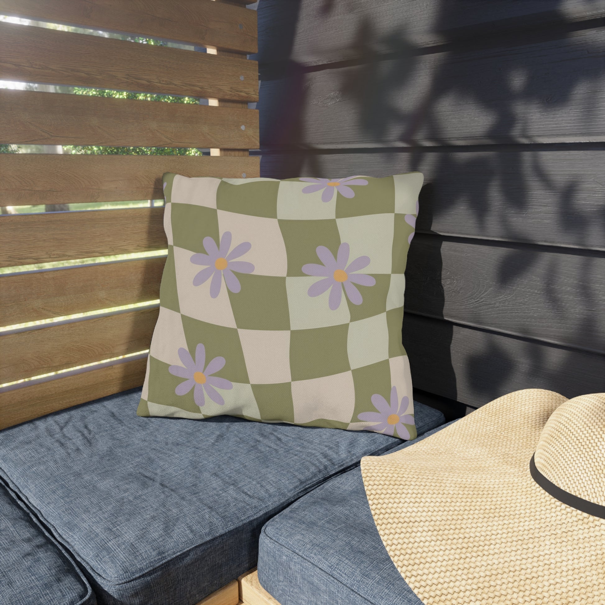 Square floral pillow accentuating patio furniture with vibrant blooms