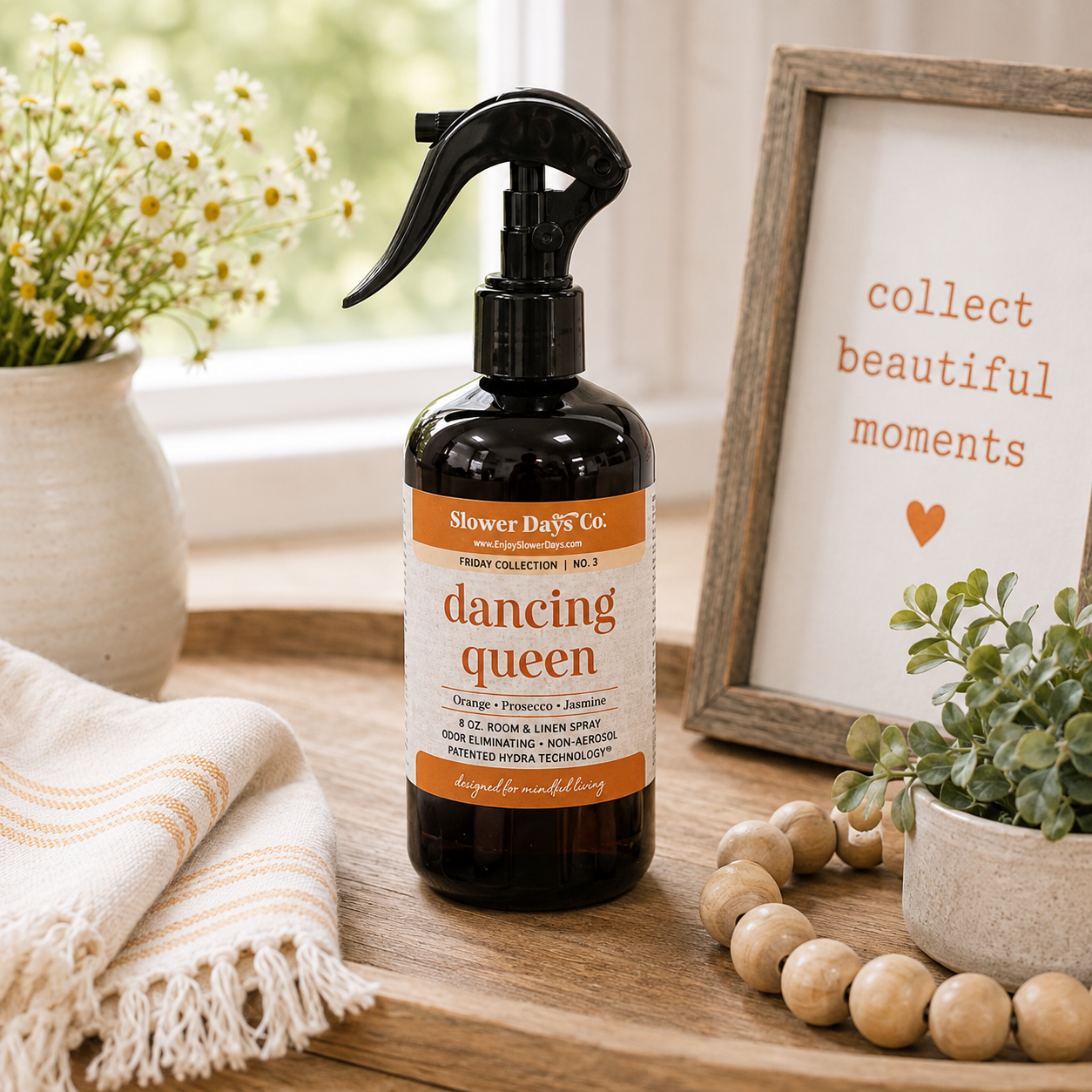 Slower Days Dancing Queen 8 oz Room & Linen Spray with black trigger sprayer displayed in a neutral farmhouse-style setting.