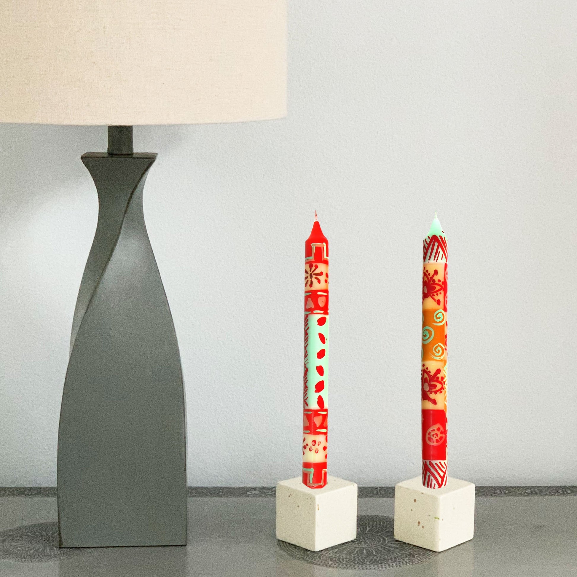 Close-up of individually painted African-style candles with geometric patterns