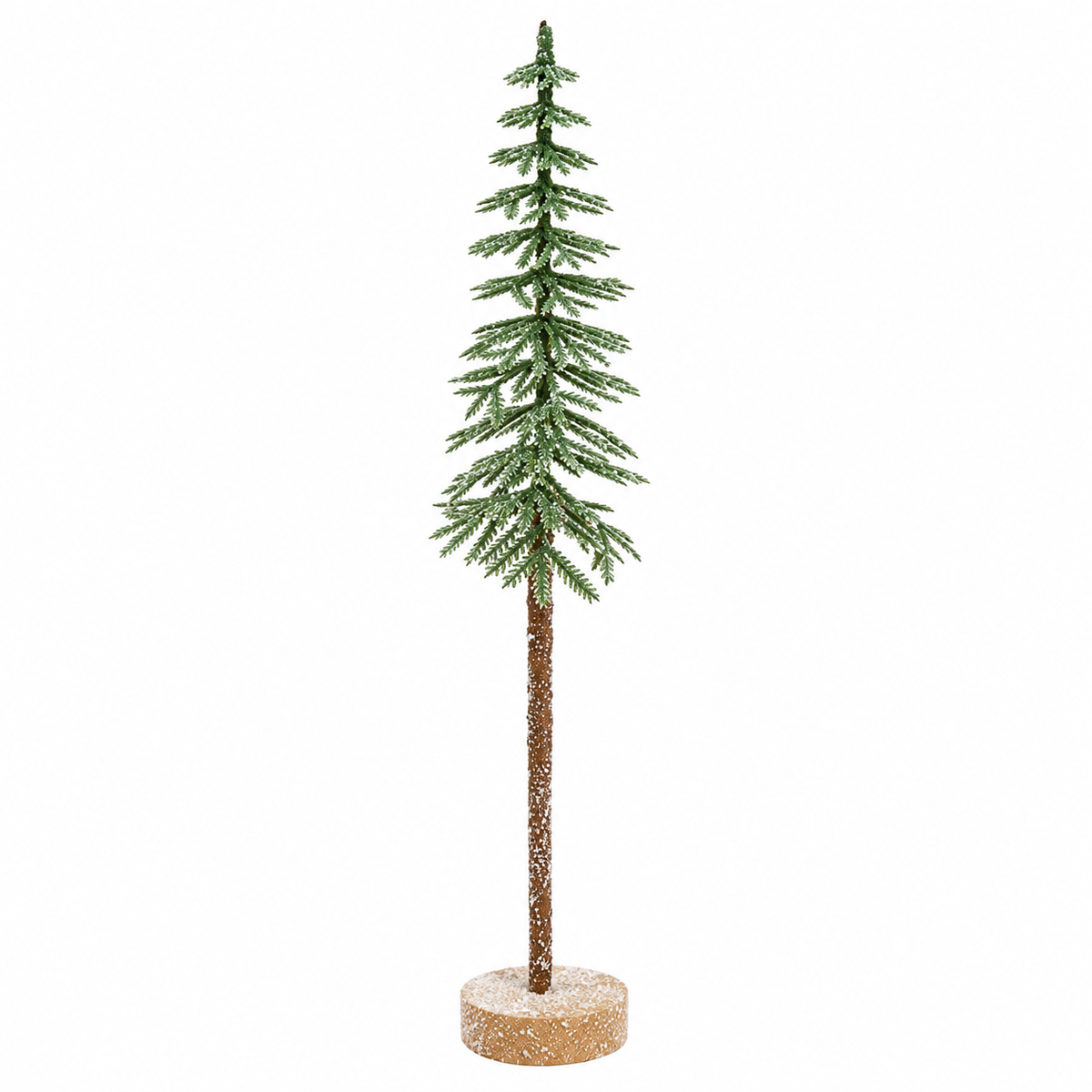 Slender tabletop evergreen tree with sparse layered green pine branches lightly dusted with faux snow, a long textured brown trunk, and a small round snow-dusted natural wood base, shown against a clean white background.