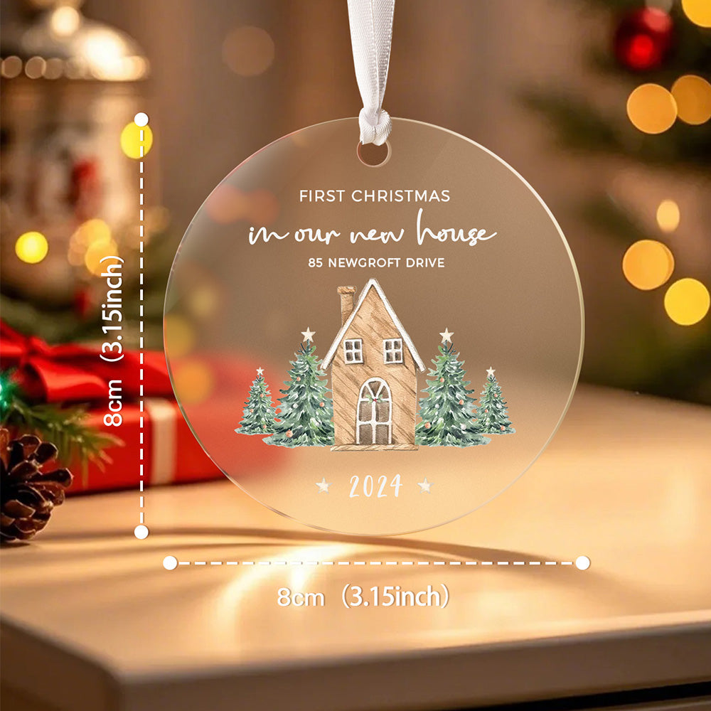 A front view of the personalized Christmas ornament featuring a house surrounded by Christmas trees with the text "First Christmas in our new home," with an overlay showing the size of the ornament.