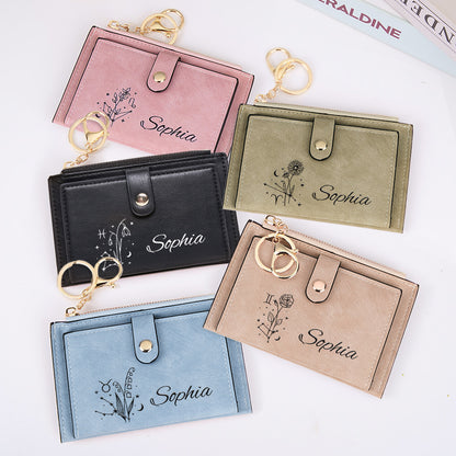 A display of five stylish vegan leather wallets in pink, green, black, blue, and tan/beige, each featuring a customizable zodiac birth flower design, perfect for daily use and special occasions.