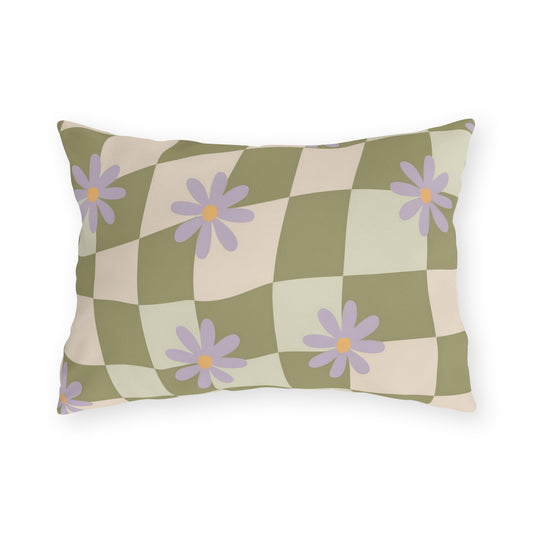 Floral outdoor lumbar pillow with green checkered background and bright garden-inspired blooms, styled for patio seating decor