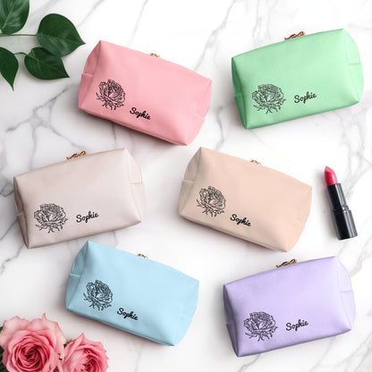 A view of 6 makeup bags in different colors: light pink, pink, green, beige, blue, and purple, each featuring a personalized birth flower design for a unique touch.