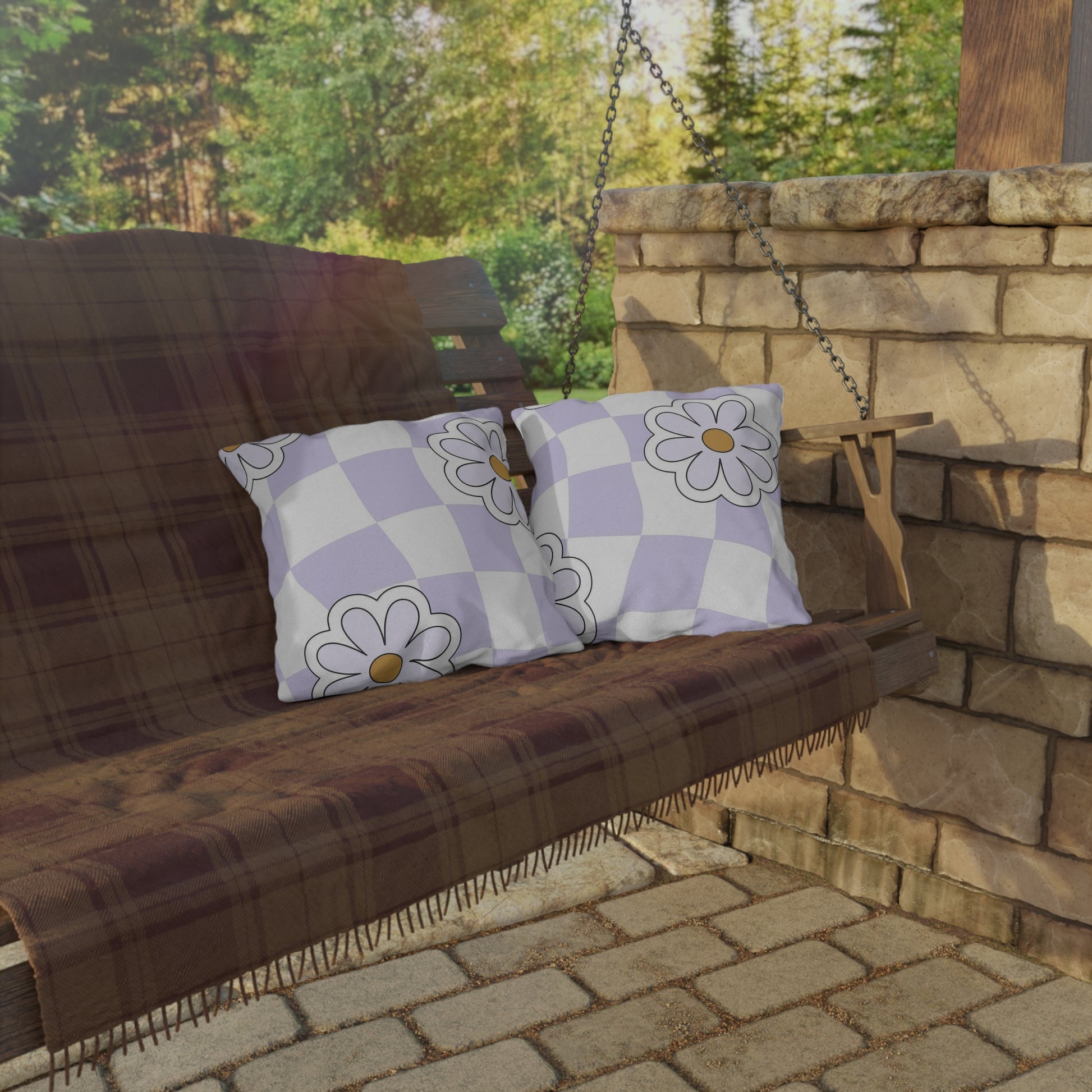 Cozy garden pillow styled on a backyard lounge chair with potted plants
