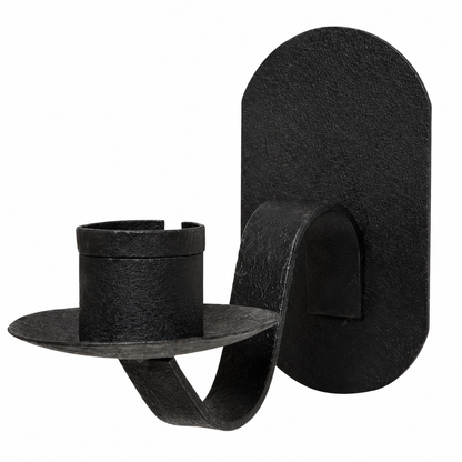 Small black metal wall candleholder with a hanging back and simple iron design for displaying beside artwork or wall accents.