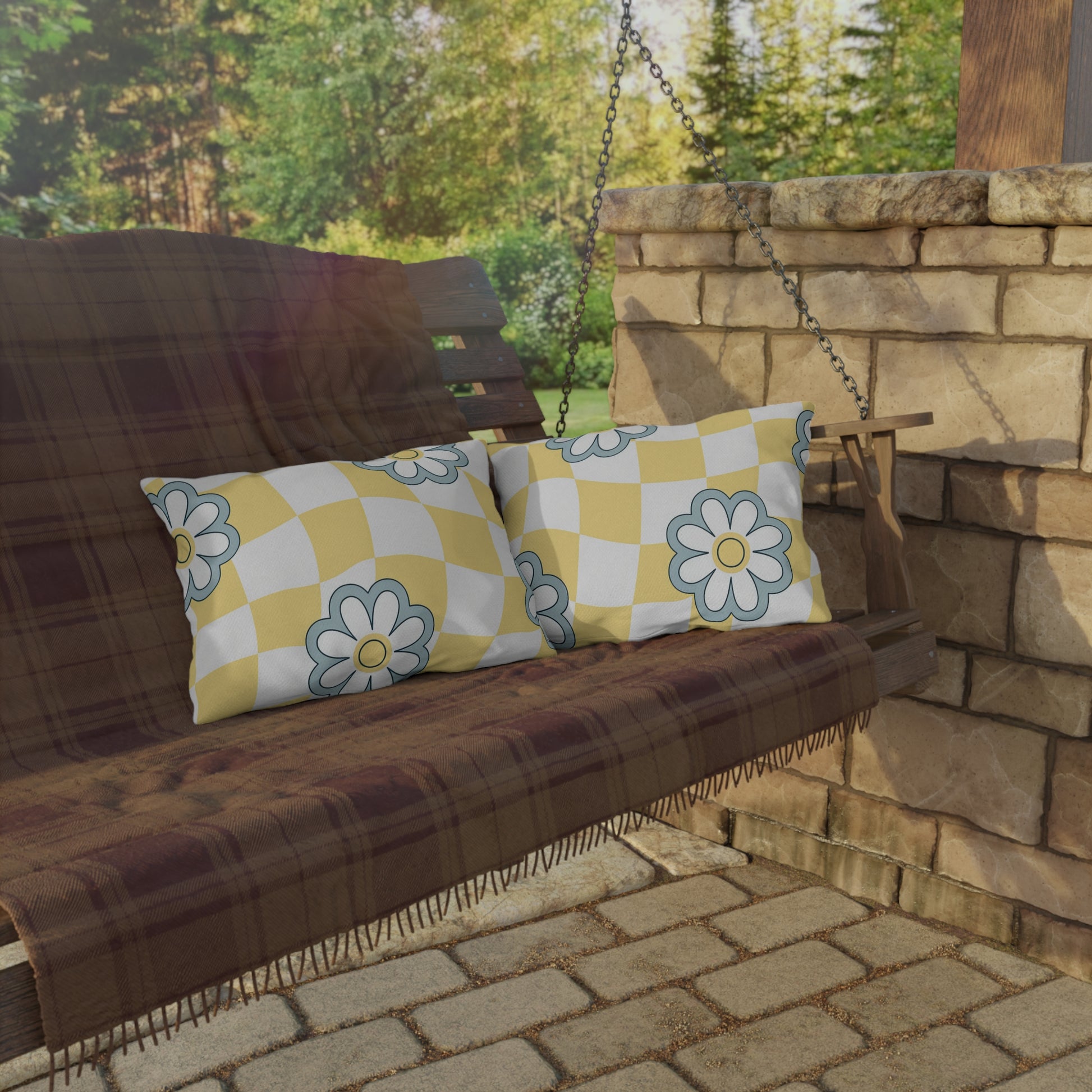 Weather-resistant lumbar cushion featuring a blue floral pattern over checkered print