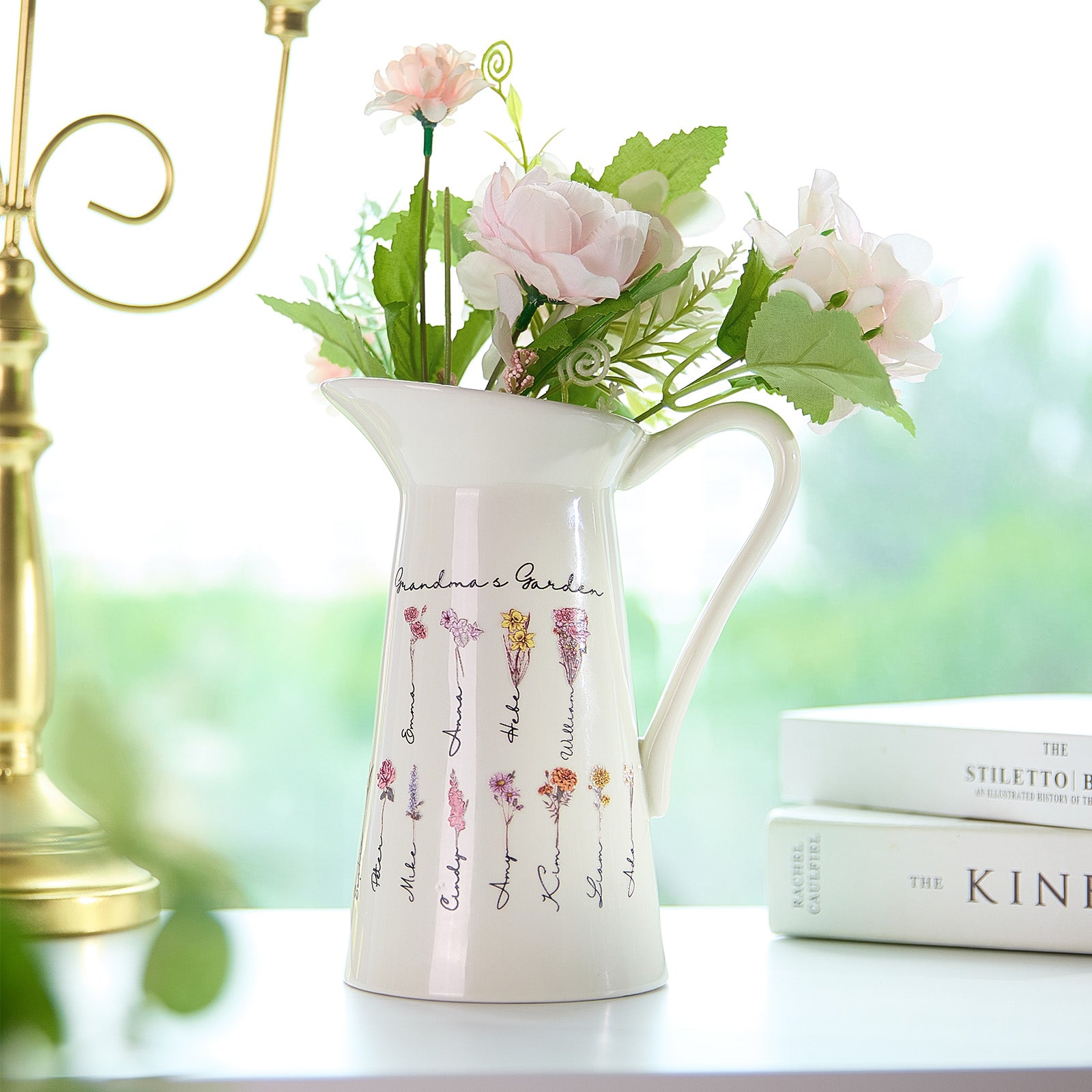 A pitcher-shaped vase featuring "Grandma's Garden" text, customizable with up to 12 names and birth flowers, creating a personalized and meaningful design that can be changed to any desired text.