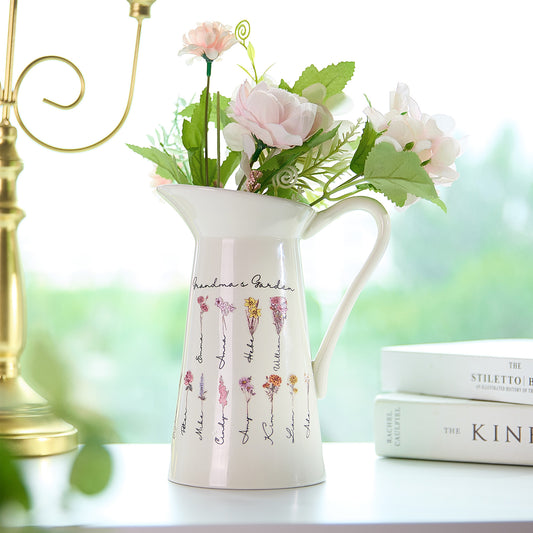 A pitcher-shaped vase featuring "Grandma's Garden" text, customizable with up to 12 names and birth flowers, creating a personalized and meaningful design that can be changed to any desired text.