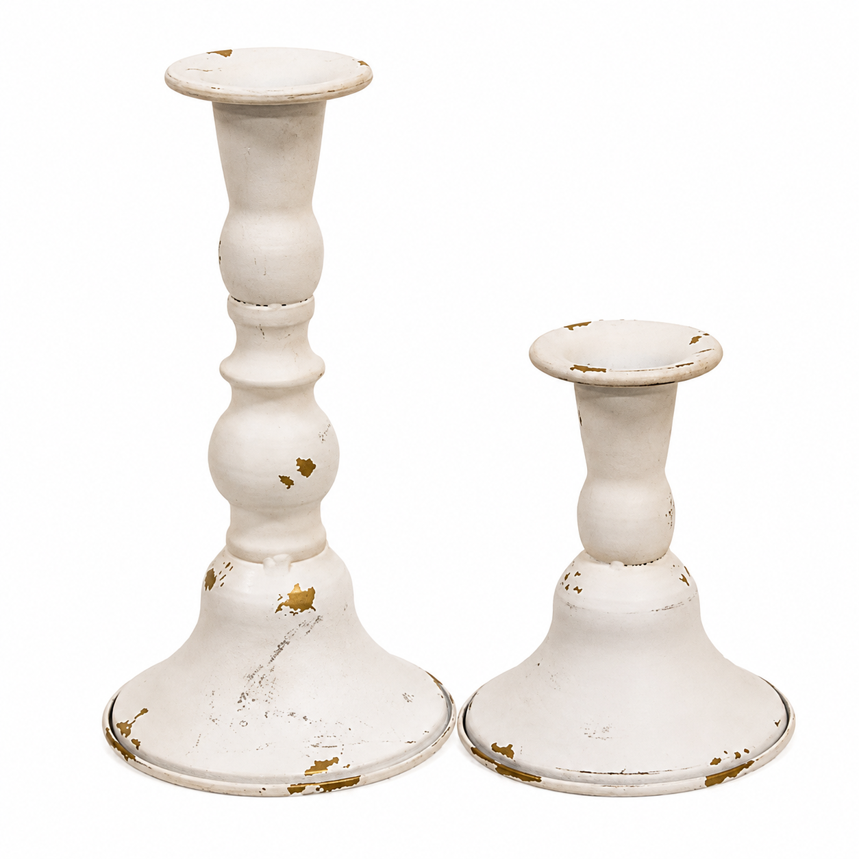 Set of two cream and gold metal taper candle holders with distressed finishes, contoured shapes, and flared bases in coordinating heights.