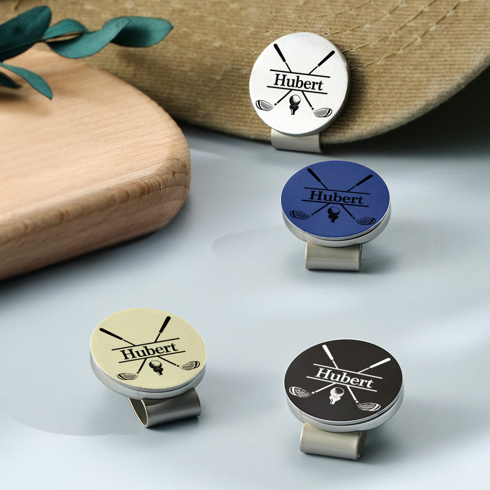 A view of four personalized golf ball markers in different color variations, each featuring a customizable design with a name or text.