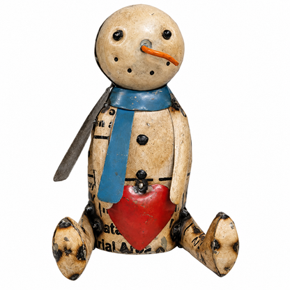 A rustic handmade snowman figurine made from recycled paper and cardboard, featuring a beige body with black printed text, a blue scarf, a red heart, and a small orange carrot nose, set against a plain white background.