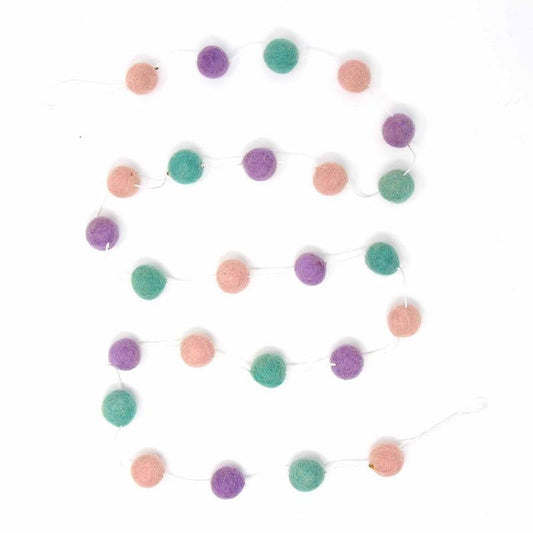 Handcrafted felt pom pom garland in pink, lavender, and turquoise, handmade in Nepal by women artisans.