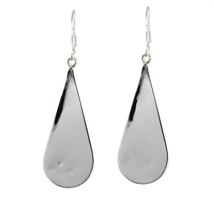 Fair Trade dangle earrings featuring natural shell and silver-tone metal.