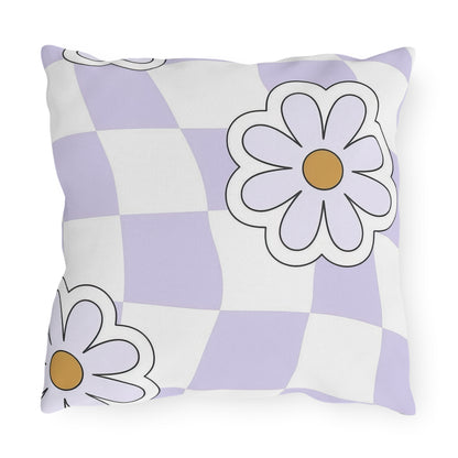 Outdoor throw pillow with floral pattern displayed on wooden deck seating
