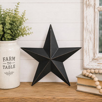 Antique black metal barn star with rusty brown detailing and a weathered primitive finish.