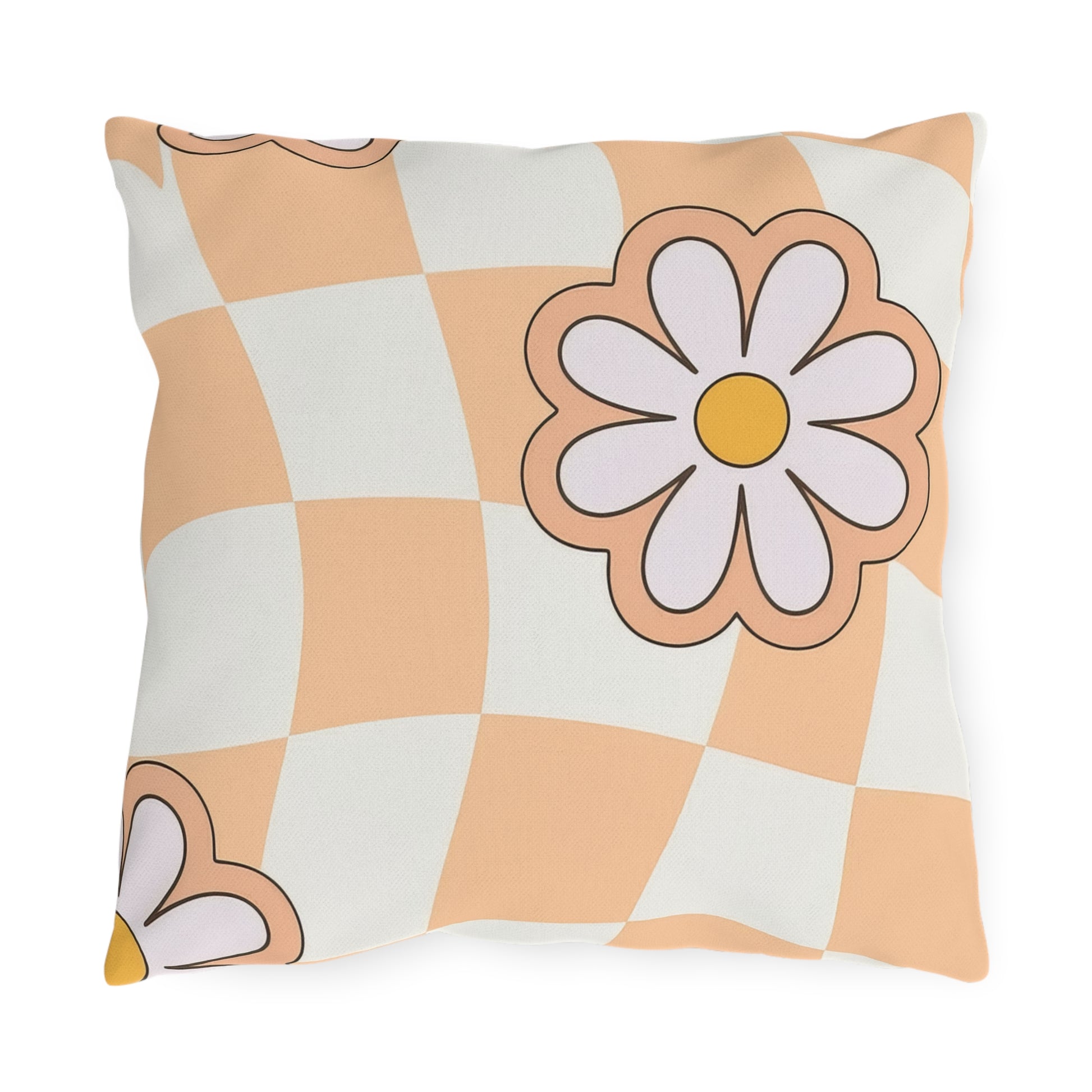 Square floral outdoor pillow with daisy pattern in orange, black, cream, and white on garden bench