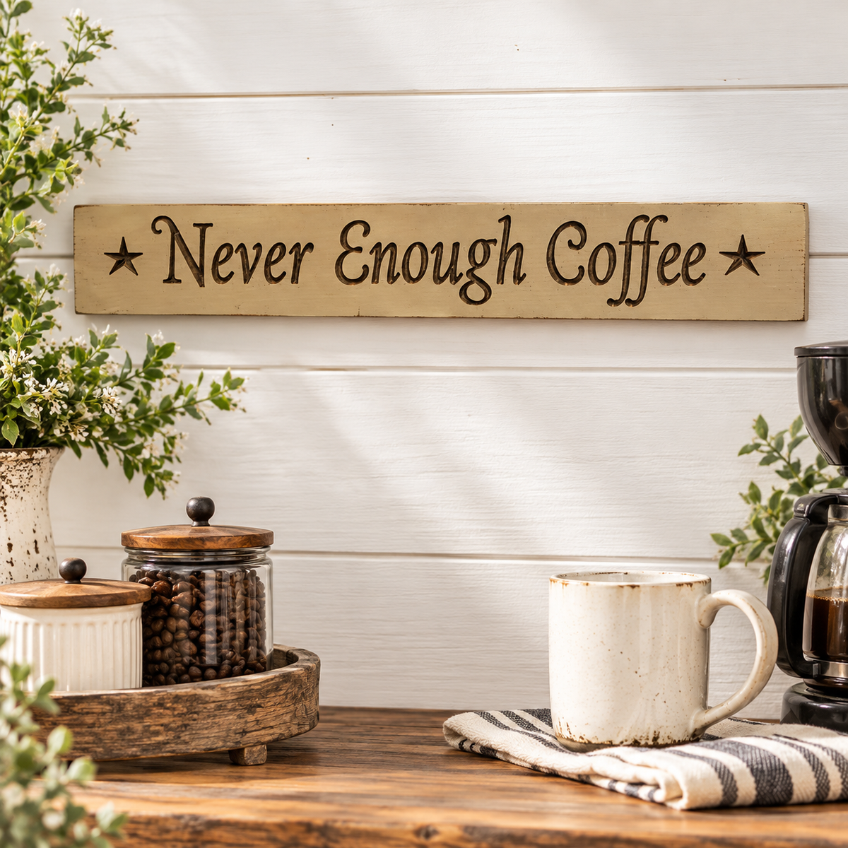 A rustic wooden sign reading 'Never Enough Coffee' with star accents, displayed on a white shiplap wall above a wooden table styled with a coffee maker, mugs, and jars of coffee beans.