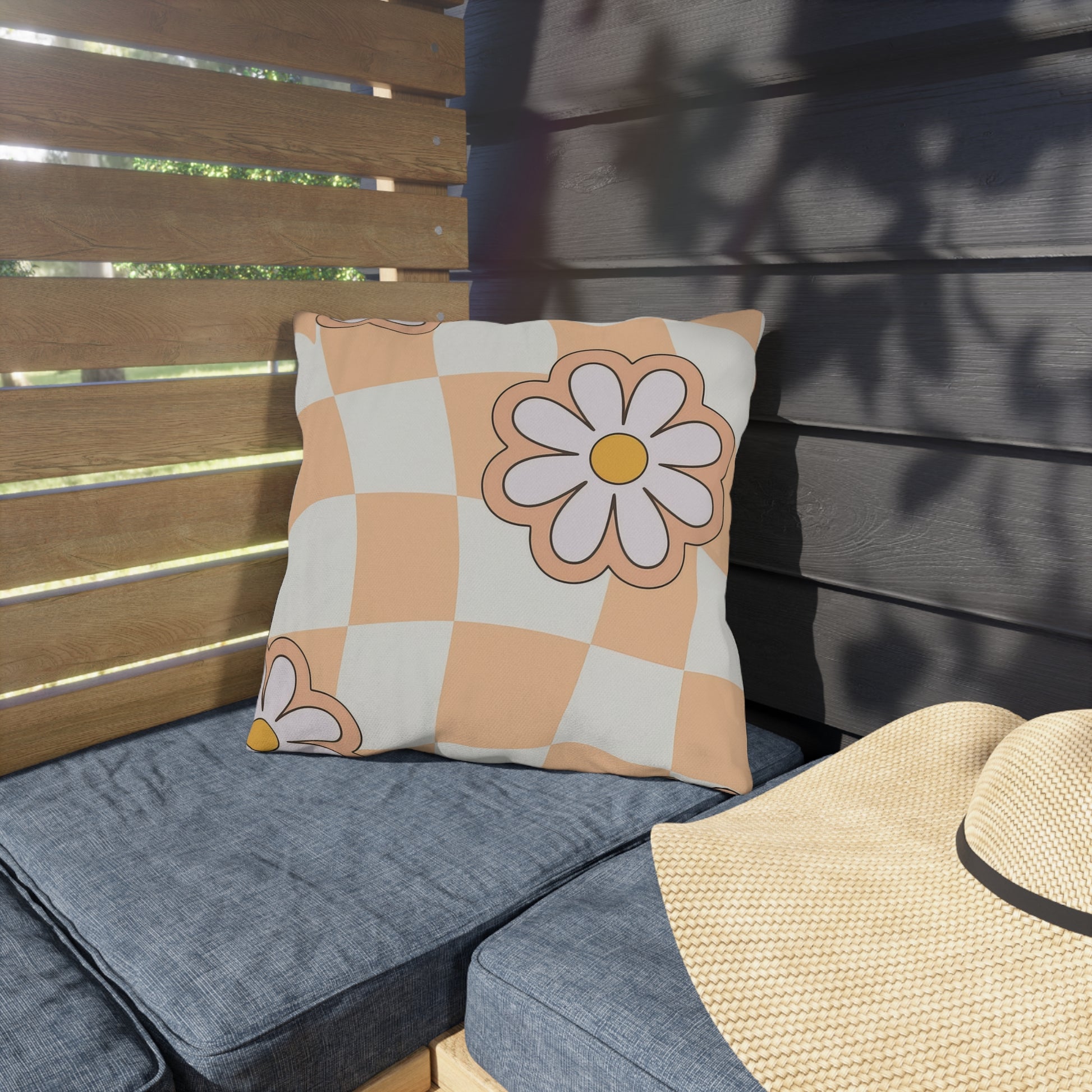 Square garden cushion with floral design shown on porch swing