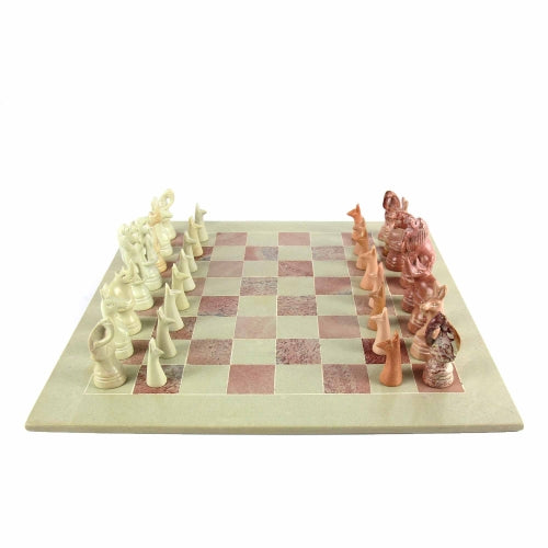 Hand-carved soapstone chess set with animal pieces on a pink and white 15-inch board, crafted by Kenyan artisans.