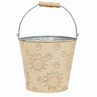 A galvanized metal garden bucket with a beige sunflower pattern, featuring a curved silver wire handle with a light wood grip.