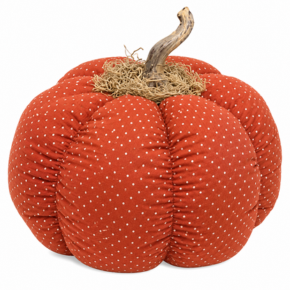 A decorative fabric pumpkin with a rust-orange color, covered in small white polka dots, featuring a textured straw-colored stem on a plain white background.