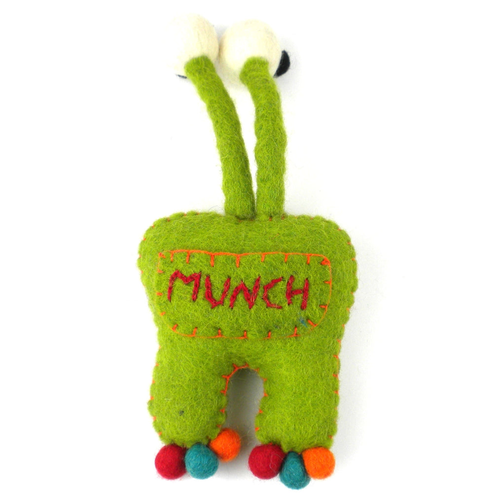 Front view of green wool felt monster with white teeth, large eyes, and pocket for tooth storage