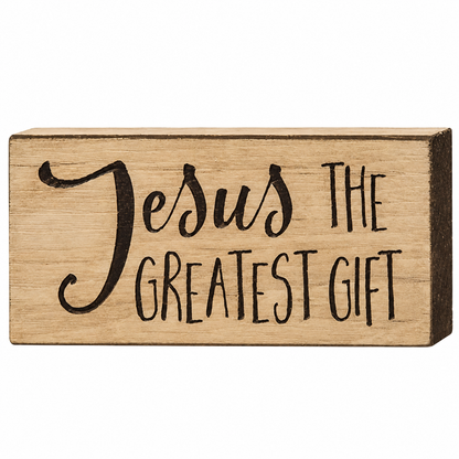 A rectangular wooden decorative block with the phrase 'Jesus THE GREATEST GIFT' in black lettering, shown on a plain white background.