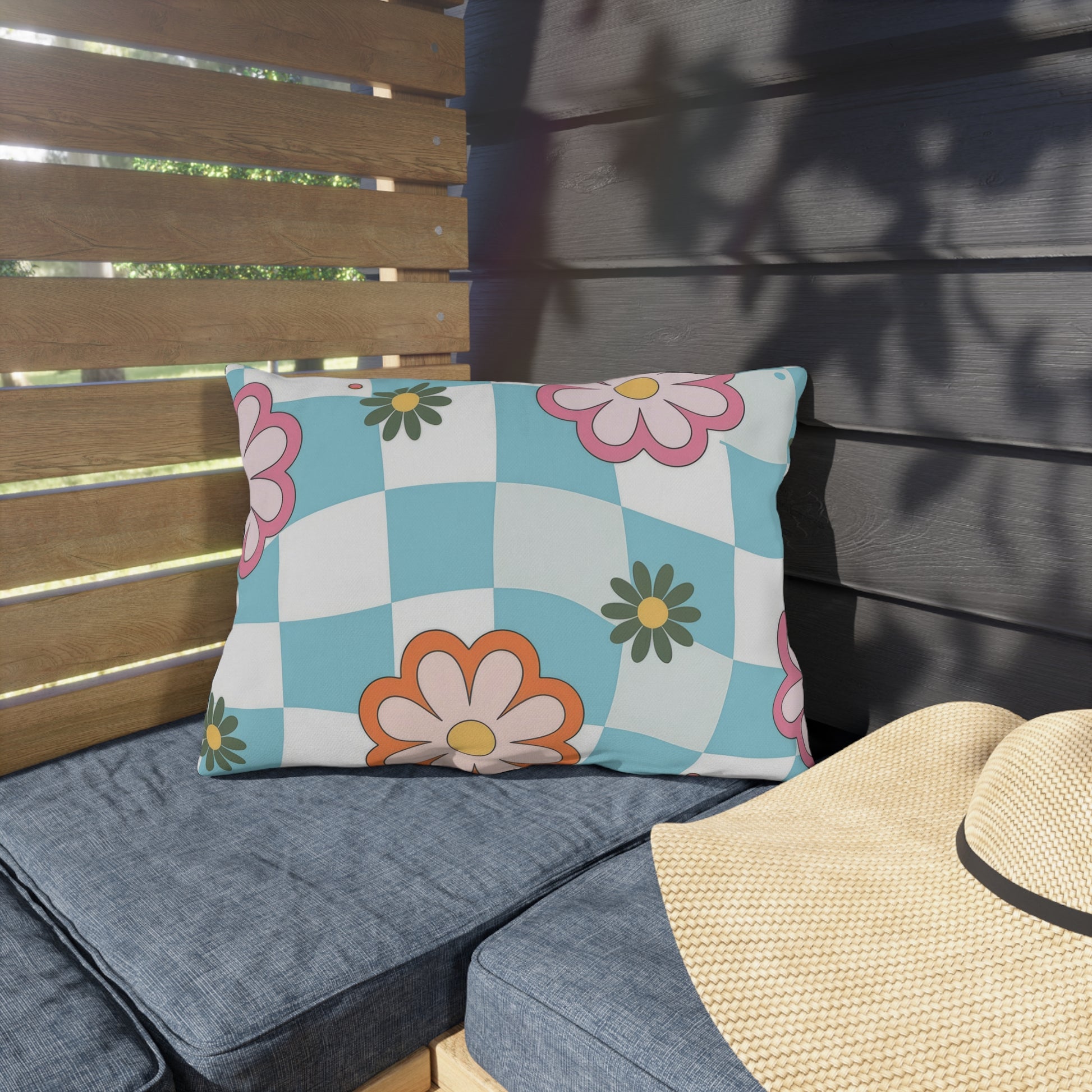 Double-sided floral lumbar pillow placed on wooden outdoor seating