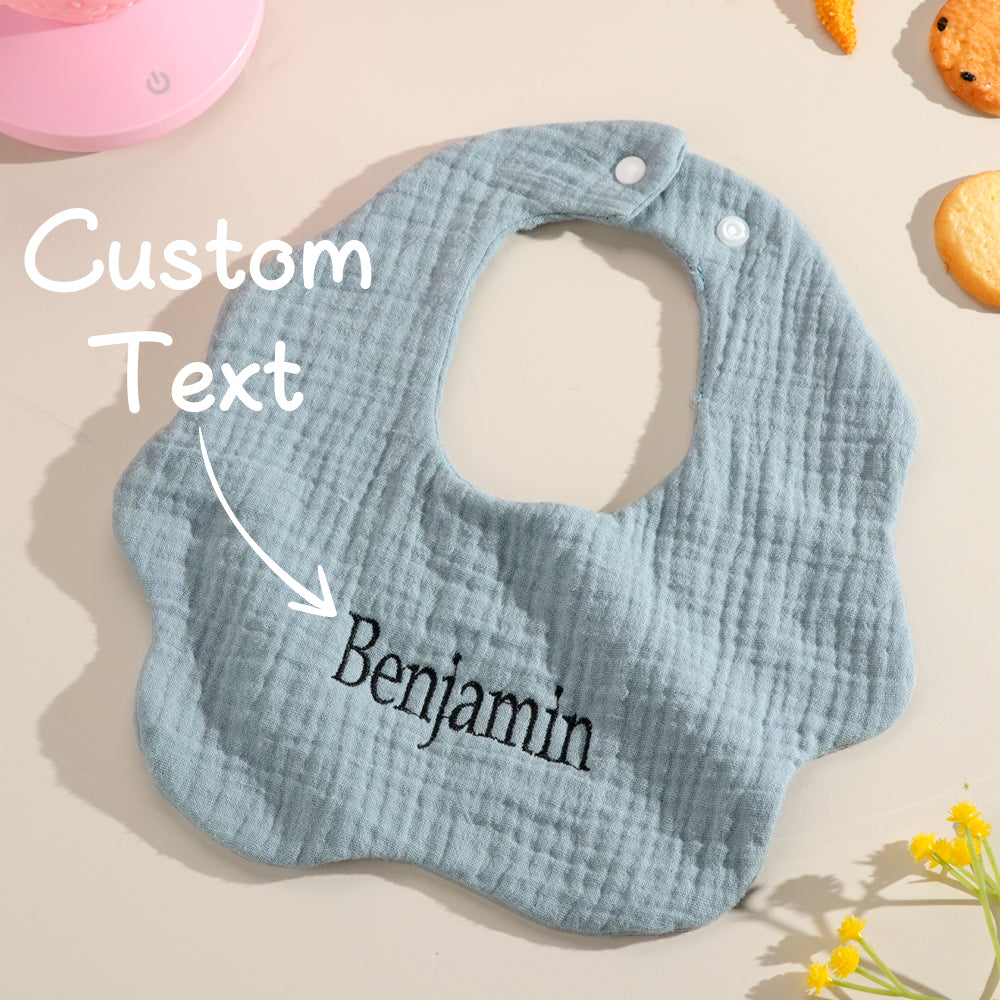 Customizable blue baby bib featuring an overlay text option for personalized embroidery. Perfect for baby showers, first birthdays, or a thoughtful gift for a newborn.