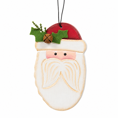 A hand-painted wooden Santa Claus face ornament with a red hat, white beard, and green holly accents, hanging from a black string on a white background.