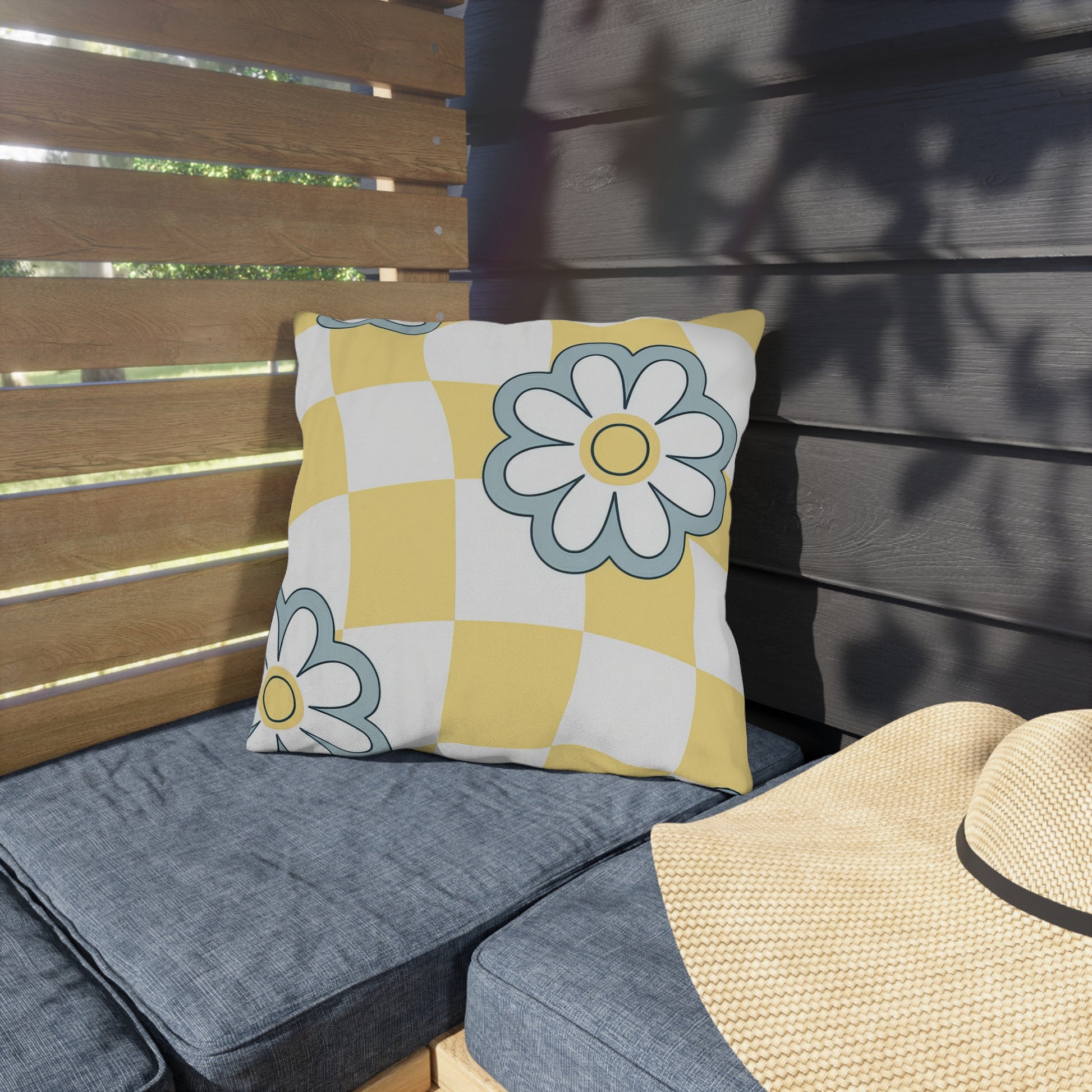 Weather-resistant checkered garden pillow with blue and white floral overlay