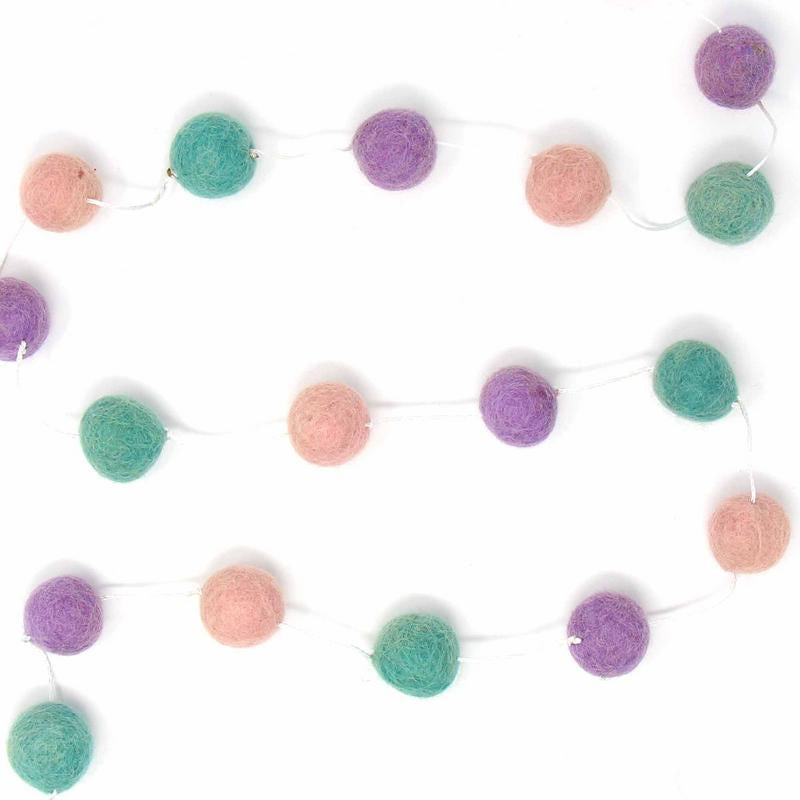 Close-up of colorful wool felt pom poms, part of an eco-friendly and fair trade home decor collection.